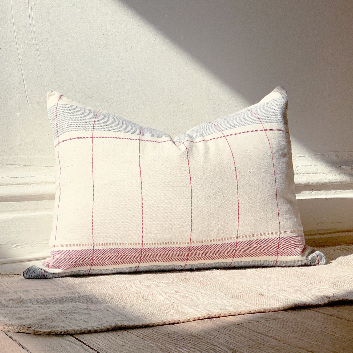 Natural cotton throw pillow with navy blue and pink accents