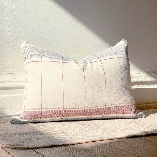 Natural cotton throw pillow with navy blue and pink accents